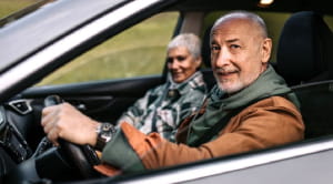 Senior couple sat in a car